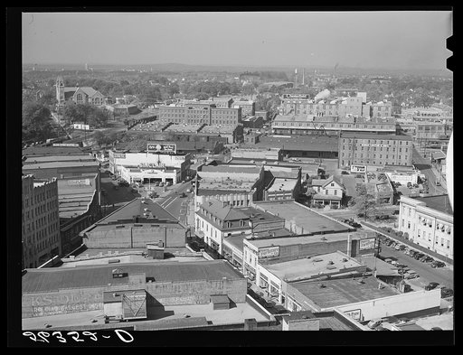 Five points, center of city, with Chesterfield cigarette factories in background. Durham, North Carolina