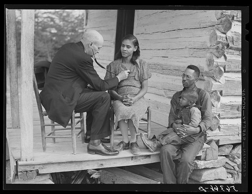 Untitled photo, possibly related to: Dr. S.A. Malloy examining Louis Graves and his family on their front porch. They are FSA (Farm Security Administration) borrowers. Caswell County, North Carolina