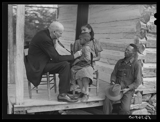 Untitled photo, possibly related to: Dr. S.A. Malloy examining Louis Graves and his family on their front porch. They are FSA (Farm Security Administration) borrowers. Caswell County, North Carolina