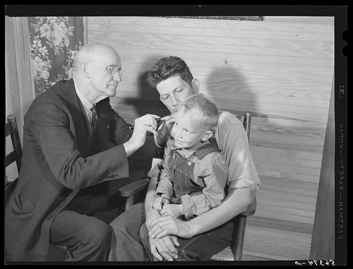 Dr. S.A. Malloy examining Mrs. William H. Willis and her family. Mr. Willis is a FSA (Farm Security Administration) borrower. Blanch, Caswell County, North Carolina