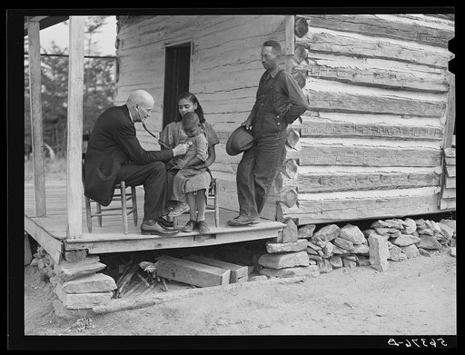 Dr. S.A. Malloy examining Louis Graves and his family on their front porch. They are FSA (Farm Security Administration) borrowers. Caswell County, North Carolina