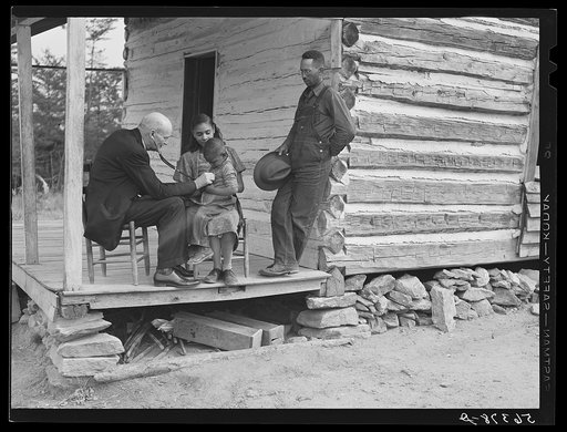 Untitled photo, possibly related to: Dr. S.A. Malloy examining Louis Graves and his family on their front porch. They are FSA (Farm Security Administration) borrowers. Caswell County, North Carolina