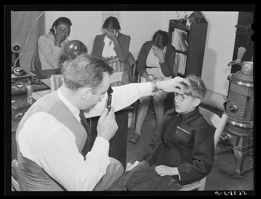 A FSA (Farm Security Administration) borrower's son being examined in the eye clinic held in the county welfare office in cooperation with the state committee to aid the blind. Yanceyville, Caswell County, North Carolina