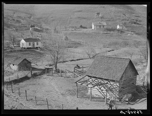 Noah Garland's barns and home on the hillside. His neighbor's house is on the right. Southern Appalachian Project near Barbourville, Knox County, Kentucky
