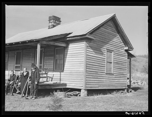 Untitled photo, possibly related to: Dutton ("Dut") Calleb and his family with their homemade hoes on the porch of their home. Southern Appalachian Project near Barbourville, Knox County, Kentucky
