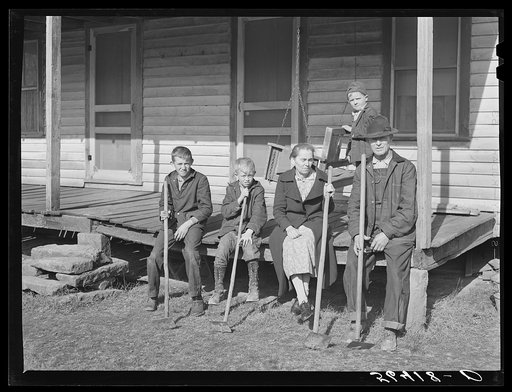 Dutton ("Dut") Calleb and his family with their homemade hoes on the porch of their home. Southern Appalachian Project near Barbourville, Knox County, Kentucky