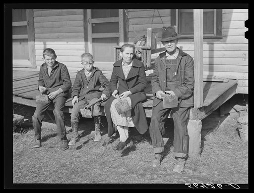 Untitled photo, possibly related to: Dutton ("Dut") Calleb and his family with their homemade hoes on the porch of their home. Southern Appalachian Project near Barbourville, Knox County, Kentucky