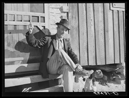 Noah Garland sitting on the steps of his son's home. Southern Appalachian Project near Barbourville, Knox County, Kentucky
