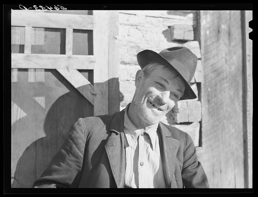 Noah Garland sitting on the steps of his son's home. Southern Appalachian Project near Barbourville, Knox County, Kentucky