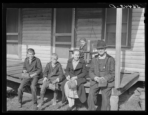 Untitled photo, possibly related to: Dutton ("Dut") Calleb and his family with their homemade hoes on the porch of their home. Southern Appalachian Project near Barbourville, Knox County, Kentucky