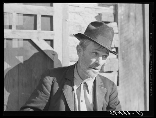 Noah Garland sitting on the steps of his son's home. Southern Appalachian Project near Barbourville, Knox County, Kentucky