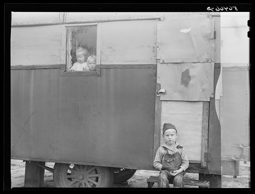 Children looking out of trailer window. Trailer where C.E. Childre and family live in highway about three miles from Fort Benning. He is an auto mechanic and came up to Columbus, Georgia two weeks ago from Albany, Georgia and now works at Columbus Motor Company. They couldn't find any other place to