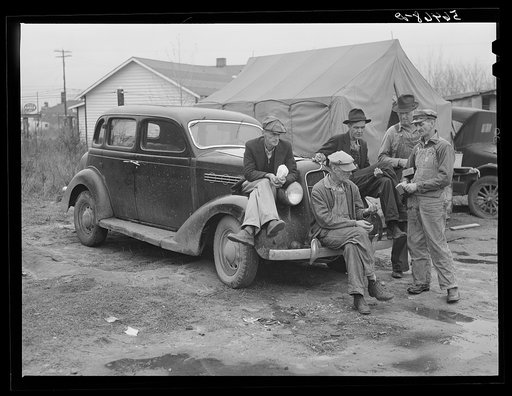 Untitled photo, possibly related to: Men on car by tents. Construction workers in front of tents. Names: William Allen Jones, Fort Benning, Paul Knight, Fort Benning, J.F. Goza, C.D. Brownlee and B.I. Juhan. For space only in W.T. Mullis' backyard they pay two dollars a week. Two of them are now wor