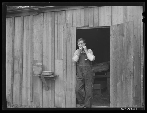 Untitled photo, possibly related to: Construction workers from Monroe, Louisiana, washing in front of their shack. Water must be hauled from a nearby church faucet. They are living on government property (no rent) while working at Camp Livingston near Fort Beauregard, Alexandria, Louisiana