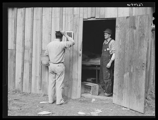 Untitled photo, possibly related to: Construction workers from Monroe, Louisiana, washing in front of their shack. Water must be hauled from a nearby church faucet. They are living on government property (no rent) while working at Camp Livingston near Fort Beauregard, Alexandria, Louisiana
