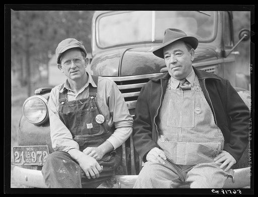 Construction workers from Monroe, Louisiana. Sitting on car in front of their shacks before leaving for evening shift. Camp Livingston, Alexandria, Louisiana