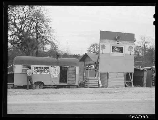 Untitled photo, possibly related to: Signs and trailer with tattoo artist on highway near Fort Beauregard. Alexandria, Louisiana