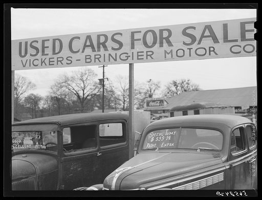 Untitled photo, possibly related to: Used cars for sale with signs and prices at service station on main highway near Alexandria, Louisiana