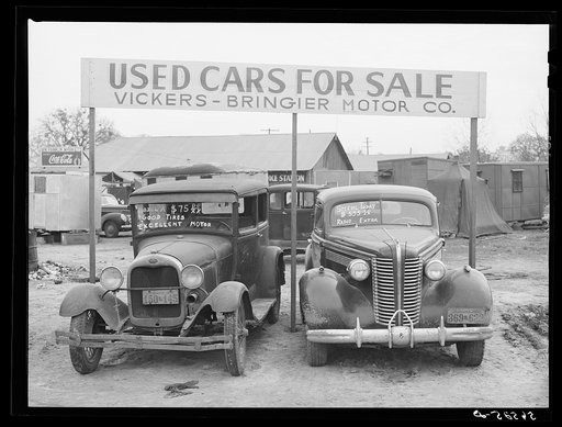 Untitled photo, possibly related to: Used cars for sale with signs and prices at service station on main highway near Alexandria, Louisiana