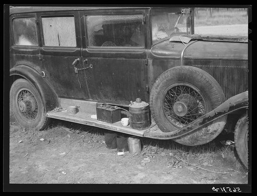 Untitled photo, possibly related to: Close-up of car from Mississippi used for sleeping as well as shelter and traveling. Evidences of cooking outside are beside it. On highway near Camp Livingston. Alexandria, Louisiana