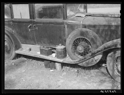 Close-up of car from Mississippi used for sleeping as well as shelter and traveling. Evidences of cooking outside are beside it. On highway near Camp Livingston. Alexandria, Louisiana