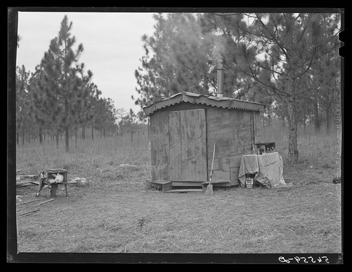 Camp Livingston construction worker's shack near Fort Beauregard. These are along the main highway on government property so they do not have to pay rent. Most of the people cook outdoors. They haul water from a nearby church faucet. There are no sanitary facilities and most of them have brought the