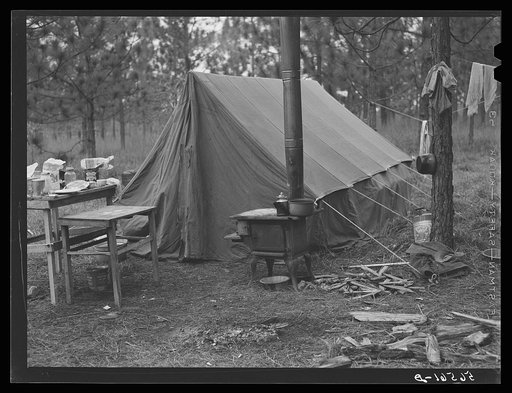 Camp Livingston worker's tent near Fort Beauregard, these are along the main highway on government property so they do not have to pay rent. Most of the people cook outdoors and haul water from a nearby church faucet.  There are no sanitary facilities and most of them, who live in tents or shacks, h