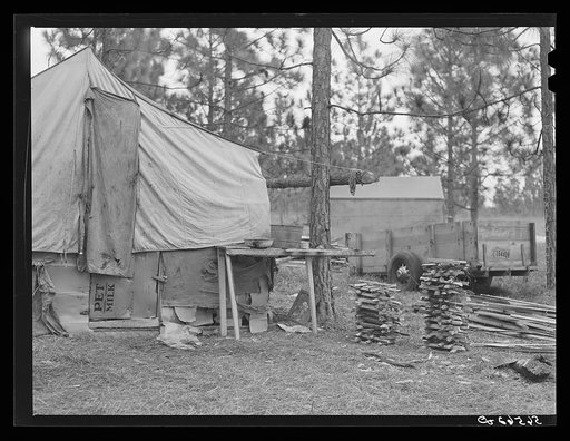 Camp Livingston construction worker's shack and tents near Fort Beauregard. These are along the main highway on government property so they do not have to pay rent. Most of the people cook outdoors and haul water from a nearby church faucet. There are no sanitary facilities and most of them have bro