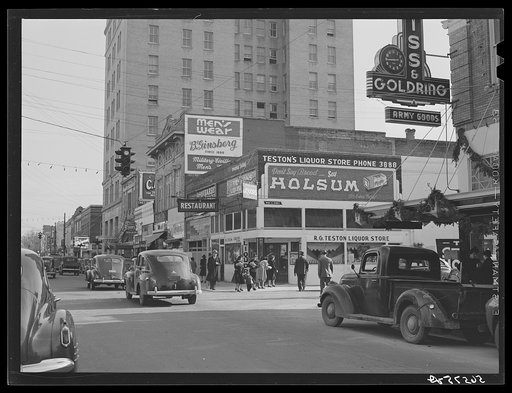 Corner building in center of Alexandria showing signs and advertising Army and military wearing apparel and goods