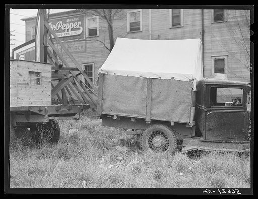 Untitled photo, possibly related to: Converted canvas-topped truck (self-built), used by six construction workers for the past two months, in which they sleep in three shifts; parked in on highway to Camp Livingston. Alexandria, Louisiana