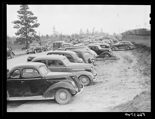 Untitled photo, possibly related to: Parked cars off side of highway near entrance to Camp Claiborne all belonging to construction workers, this roadside congestion extends for over a mile. Louisiana