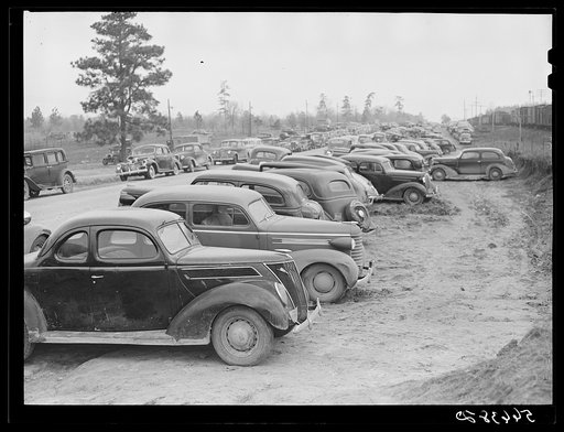 Untitled photo, possibly related to: Parked cars off side of highway near entrance to Camp Claiborne all belonging to construction workers, this roadside congestion extends for over a mile. Louisiana