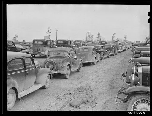 Untitled photo, possibly related to: Parked cars off side of highway near entrance to Camp Claiborne all belonging to construction workers, this roadside congestion extends for over a mile. Louisiana