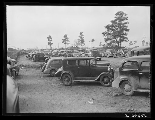 Untitled photo, possibly related to: Parked cars off side of highway near entrance to Camp Claiborne all belonging to construction workers, this roadside congestion extends for over a mile. Louisiana