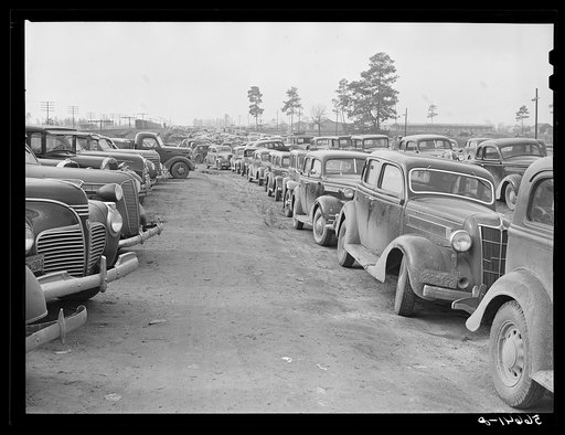 Untitled photo, possibly related to: Parked cars off side of highway near entrance to Camp Claiborne all belonging to construction workers, this roadside congestion extends for over a mile. Louisiana