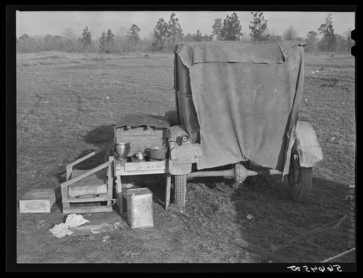 Untitled photo, possibly related to: Tent and farm truck used for sleeping and general housing by construction workers off highway near Camp Claiborne. They cook out of doors and have no sanitary conveniences. Alexandria, Louisiana