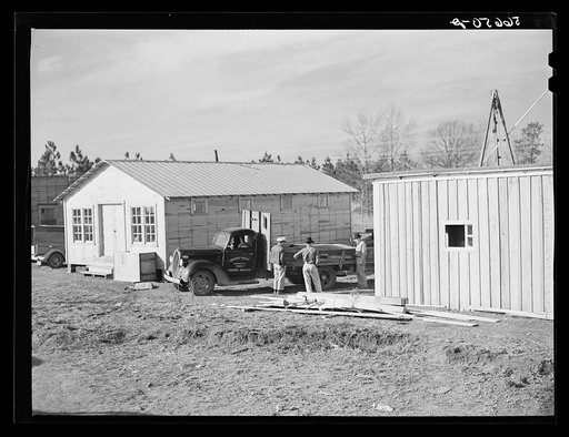 Untitled photo, possibly related to: Cars of construction workers at Camp Claiborne, Alexandria, Louisiana. New buildings on highway at Camp Claiborne. Cabins, sleeping quarters, etc., being built by private interest for construction workers. Louisiana