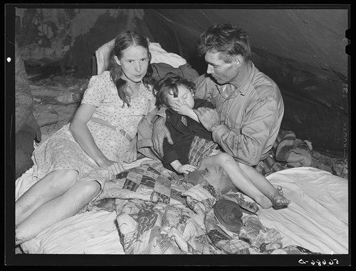 Untitled photo, possibly related to: Construction worker with wife and neighbor's child in tent home near Alexandria, Louisiana. Ten men, two women, and two children live here