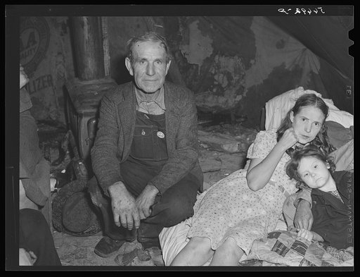 Family in tent from Georgia with neighbor's child, eight or ten men, two women, two children stay here permanently. Men sleep in shifts as construction workers. Women going to take in two neighbors' children whose tent leaks and the deluge of rain has continued for days. Alexandria, Louisiana
