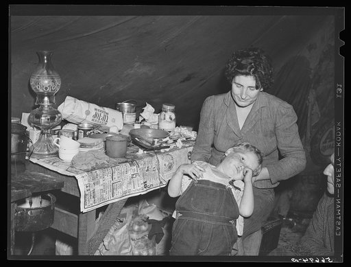 Wife and child of construction worker in tent home near Alexandria, Louisiana. Ten men, two women, and two children live here