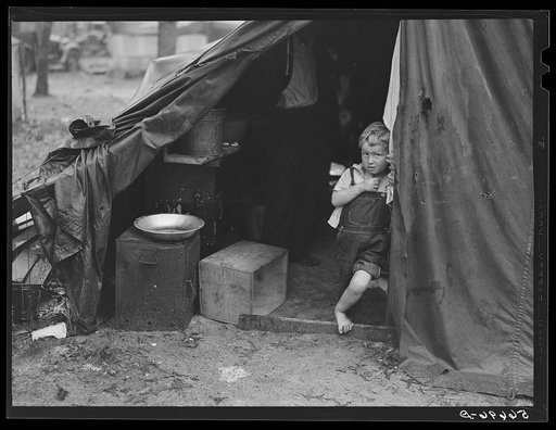 Untitled photo, possibly related to: Child of construction worker in doorway of tent home near Alexandria, Louisiana. Ten men, two women, and two children live here