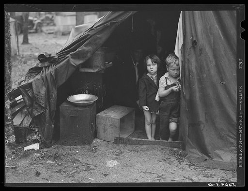 Children in tent home of construction workers. Ten men, two women and two children live here. Near Alexandria, Louisiana