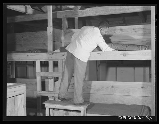 Porter making up beds in barracks. Camp Blanding, Starke, Florida