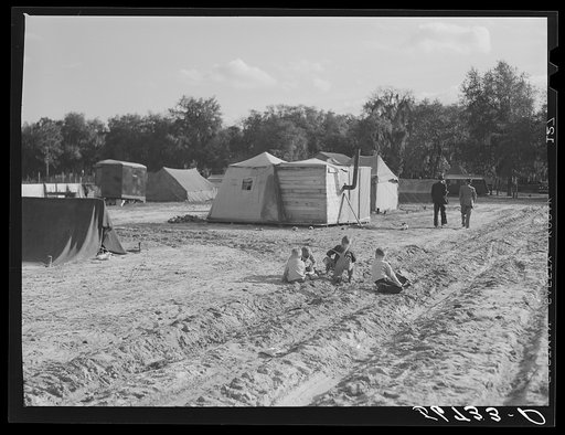 Untitled photo, possibly related to: Construction workers' children playing in front of their shacks and tents in camp near Camp Blanding. Starke, Florida