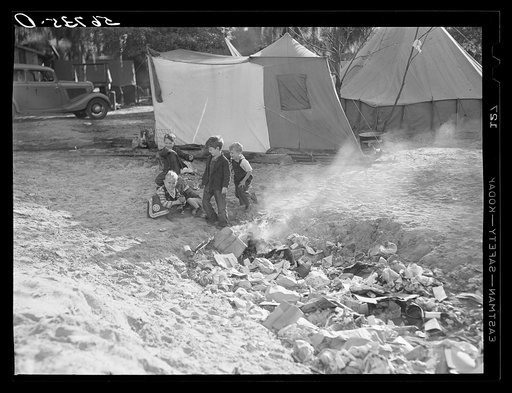 Untitled photo, possibly related to: Construction workers' children playing around garbage and rubbish heap in back of their tents. Near Camp Livingston, Alexandria, Louisiana