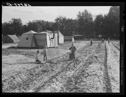 Construction workers' children playing in front of their shacks and tents in camp near Camp Blanding. Starke, Florida
