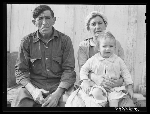 Spanish muskrat trapper, his wife and their adopted child by their marsh camp. Delacroix Island, Saint Bernard Parish, Louisiana