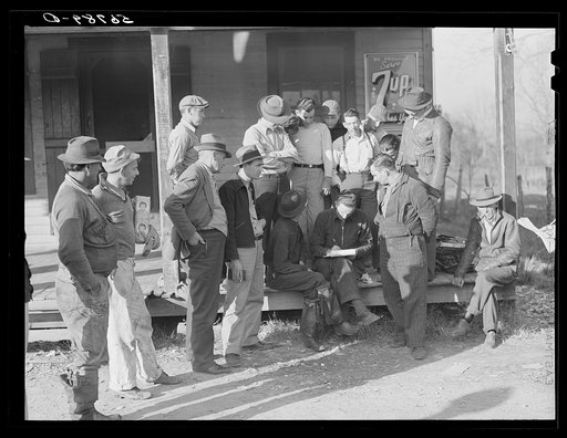 Spanish trappers and fur buyers crowd around FSA (Farm Security Administration) supervisor as he opens and reads the bids on that lot of muskrats. The auction sale is on porch of community store. Saint Bernard, Louisiana
