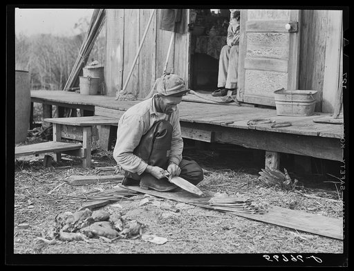 Untitled photo, possibly related to: Spanish muskrat trapper in doorway of his marsh camp. Delacroix Island, Saint Bernard Parish, Louisiana