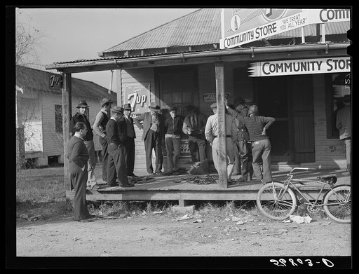 Untitled photo, possibly related to: Spanish trappers and fur buyers waiting around while muskrats are being graded during auction sale on porch of community store. Saint Bernard, Louisiana
